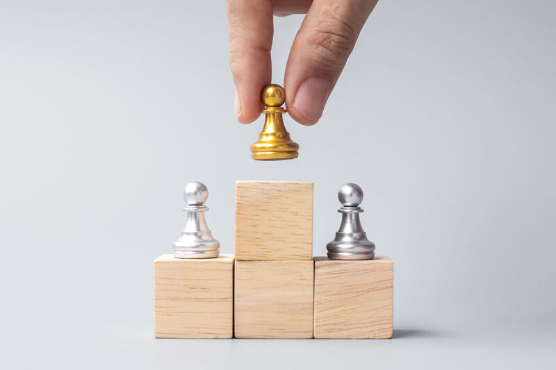 Image of blocks with golden chess piece on the top